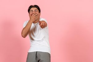 02-09-05-front-view-young-male-laughing-white-t-shirt-pink-background_140725-122140.jpg
