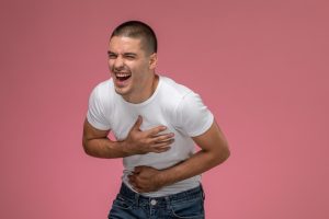 02-08-25-front-view-young-male-white-t-shirt-just-laughing-pink-background_140725-27018